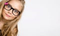 Cute blonde little girl in glasses on a white background in the