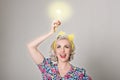 Cute blonde retro girl holding glowing light bulb - humorous con