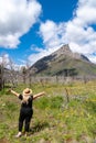 Cute blonde woman poses in a wildflower field along the Red Rock Canyon Parkway in Waterton Lakes National Park in Alberta, Canada Royalty Free Stock Photo