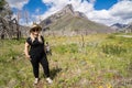 Cute blonde woman poses in a wildflower field along the Red Rock Canyon Parkway in Waterton Lakes National Park in Alberta, Canada Royalty Free Stock Photo