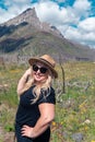 Cute blonde woman poses in a wildflower field along the Red Rock Canyon Parkway in Waterton Lakes National Park in Alberta, Canada Royalty Free Stock Photo