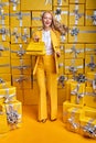 Beautiful beautiful blonde woman wearing yellow suit holding nice handbag