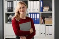 Cute blonde young office worker with documents posing in stylish outfit