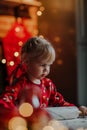 Cute blondie little girl roll out the dough for Christmas cookies