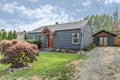 Cute blue house snap with red door and blue wooden shed Royalty Free Stock Photo