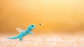 A Cute Blue Lizard with Wings Hunting a Fly Royalty Free Stock Photo