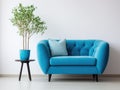 Cute blue loveseat sofa or snuggle chair and pot with branch. Interior design of modern living room with white wall