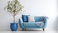 Cute blue loveseat sofa or snuggle chair and pot with plant.