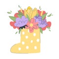 Cute bouquet of flowers with leaves  in a yellow polka dot rubber boot. Beautiful spring flowers in a cute rubber boot. Royalty Free Stock Photo