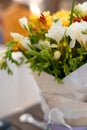 cute bouquet of natural white and yellow flowers in white paper, blurred background Royalty Free Stock Photo