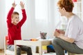 Cute boy with ADHD during session with professional therapist Royalty Free Stock Photo