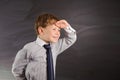 Cute boy against blackboard Royalty Free Stock Photo