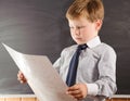 Cute boy against blackboard Royalty Free Stock Photo