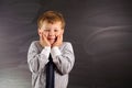 Cute boy against blackboard Royalty Free Stock Photo