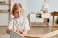 Cute Boy Assembling Wooden Chair Closeup