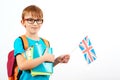 Cute boy with backpack and books holds British flag. Student learning english. English language school Royalty Free Stock Photo