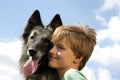 A cute boy with a Belgian shepherd