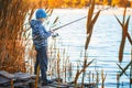 Cute boy catches fish on a summer lake Royalty Free Stock Photo