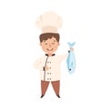 Cute Boy Chef Cooking Fresh Fish, Smiling Kid in Chef Uniform Cooking in Kitchen Cartoon Style Vector Illustration Royalty Free Stock Photo