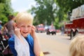 Cute Boy Child at Parade Plugging his Ears from the Loud Fire Truck Sirens