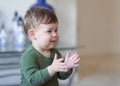 cute boy clapping his hands at home Royalty Free Stock Photo