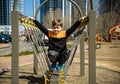 Cute boy is climbing on the playground in the schoolyard. He has a very happy face and enjoy this adventure sports alone outdoor. Royalty Free Stock Photo