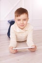 Cute boy. Computer tablet. play game, chat. Training. light interior