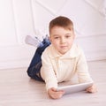 Cute boy. Computer tablet. Training. light interior