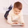 Cute boy. Computer tablet. Training. light interior Royalty Free Stock Photo