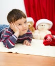 Cute boy daydreaming lying on the floor. New Year Royalty Free Stock Photo