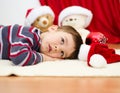 Cute boy daydreaming lying on the floor. New Year Royalty Free Stock Photo