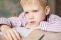 Cute boy doing his homework and looking tired. Royalty Free Stock Photo