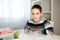 Cute boy is doing math homework. Stay at home. Stay safe. Coronavirus Royalty Free Stock Photo