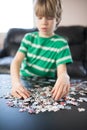 Cute boy doing a puzzle Royalty Free Stock Photo