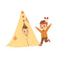 Cute boy dressed as an Indian playing with his friends in a tepee tent, kids having fun in a hut vector Illustration Royalty Free Stock Photo