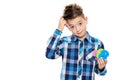 Cute boy with dyscalculia holding large colorful numbers and scratching his head. Learning disability concept.