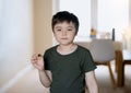 Cute boy eating chocolate cake, Happy Child looking out while eating chocolate, Portrait Kid relaxing and having snack or sweet Royalty Free Stock Photo