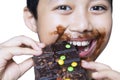 Cute boy eating chocolate on studio Royalty Free Stock Photo