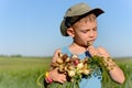 Cute Boy Eating and Holding Green Onions Royalty Free Stock Photo