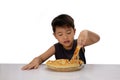 Cute boy eating pizza isolated on white background Royalty Free Stock Photo