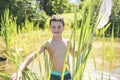 Cute Boy fishing with a net on a lake Royalty Free Stock Photo