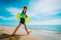 Cute boy with floatie going to swim at tropical beach Royalty Free Stock Photo