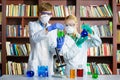 Cute boy and girl doing biochemistry research in chemistry class Royalty Free Stock Photo