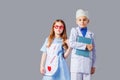 Cute boy and girl in medical uniform playing like doctors