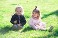 Cute boy and girl sit on grass on summer field. Baby child in green grass on spring lawn. Little kids walking in the Royalty Free Stock Photo
