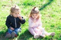 Cute boy and girl on spring field. Outdoor kids activities. Family spring holidays with children. Happy children playing Royalty Free Stock Photo