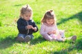 Cute boy and girl on summer field. Cute babys sit on green grass in summertime. Funny little kid on nature. Happy Royalty Free Stock Photo