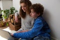 Cute boy and girl using laptop together at home Royalty Free Stock Photo