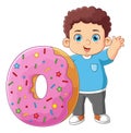 A cute boy good posing and waving with a big pink donut toy Royalty Free Stock Photo