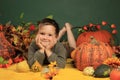 Cute boy and halloween pumpkins